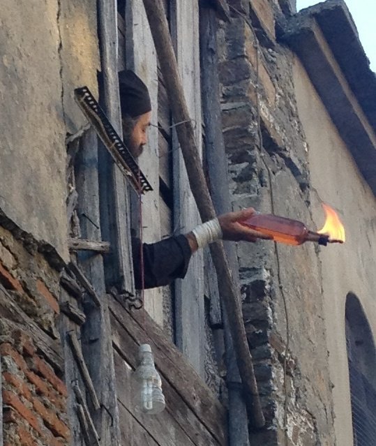 Monk holds Molotov cocktail